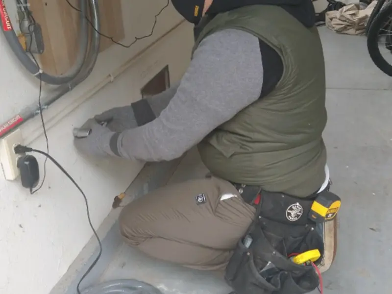Electrician performing outlet wiring in a Indiana garage